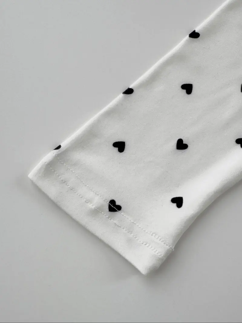 Cuff stitching detail of fitted heart print cropped top