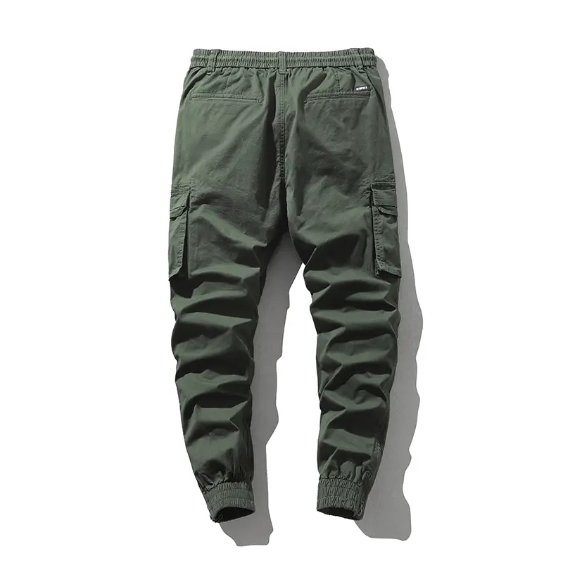 Stylish solid-color cargo pants featuring an elastic drawstring design, multiple pockets, and multiple flap details