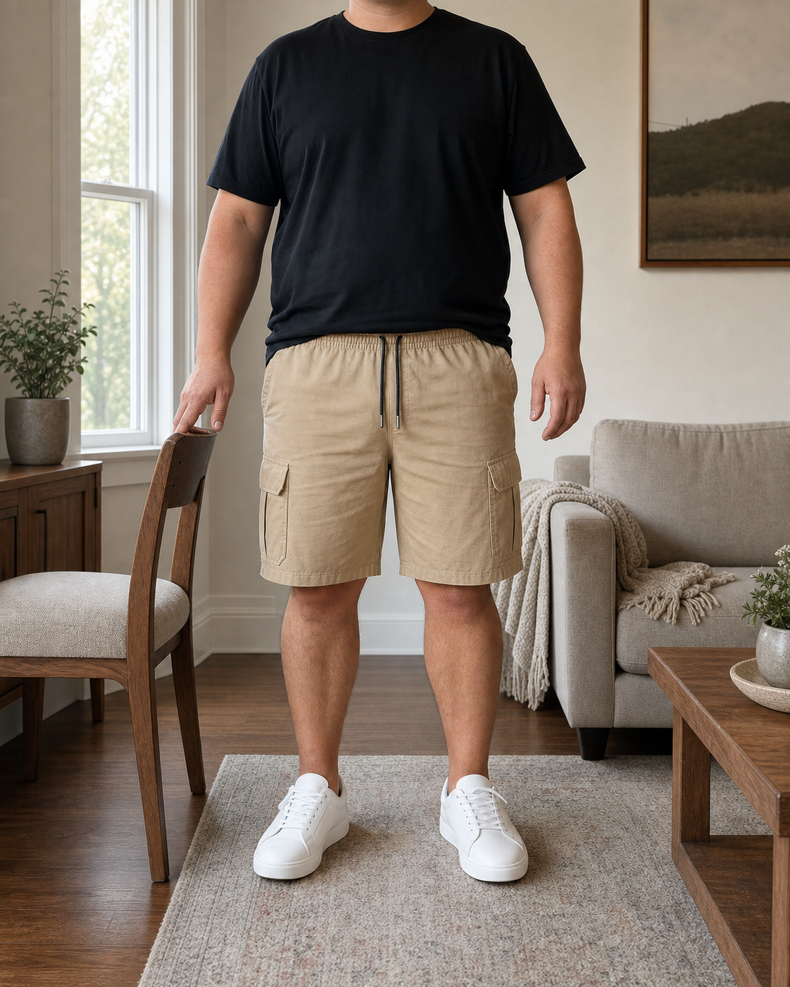 Front view of a plus-size model wearing the Beige men's cargo drawstring shorts in a modest living room