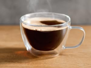 Image of hot coffee in mug with text reading coffee machine.