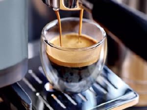 Image of espresso dripping into cup with text reading espresso machine.