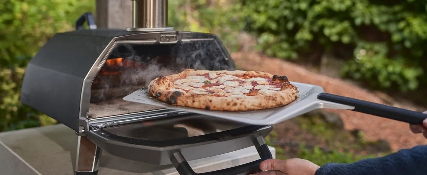 Removing a freshly cooked Neapolitan pizza from the Ooni Karu 2 Pro oven