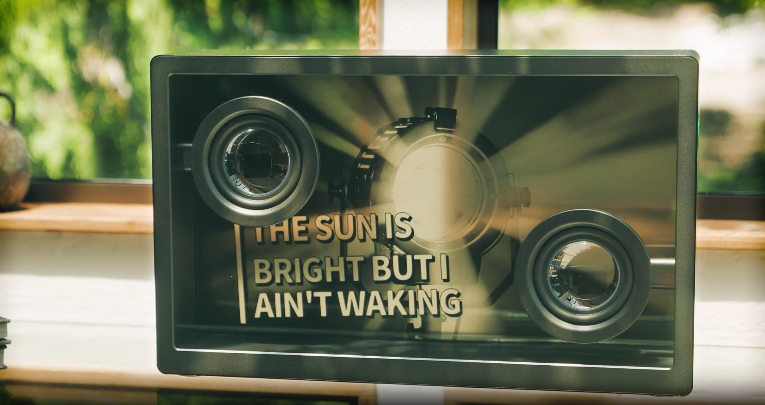 Transparent glass lyric speaker lifestyle scene with music visualization
