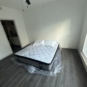 Mattress unboxing on floor with pillows