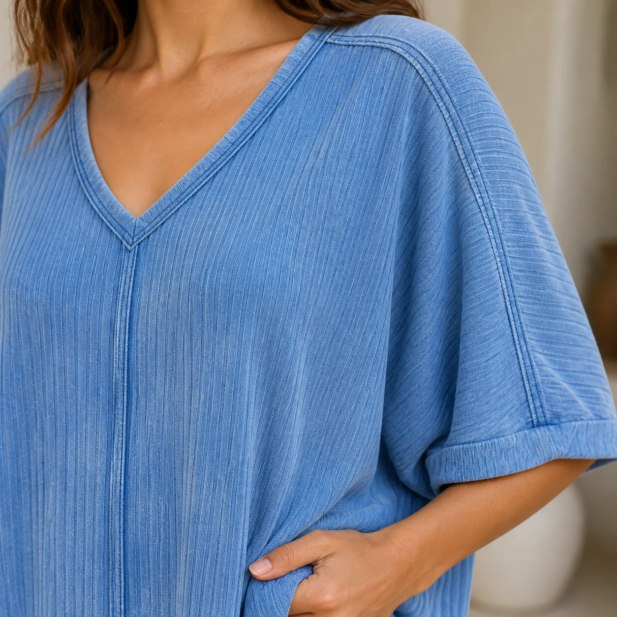 Close view of the V-neck seam and vertical ribbed acid-wash texture