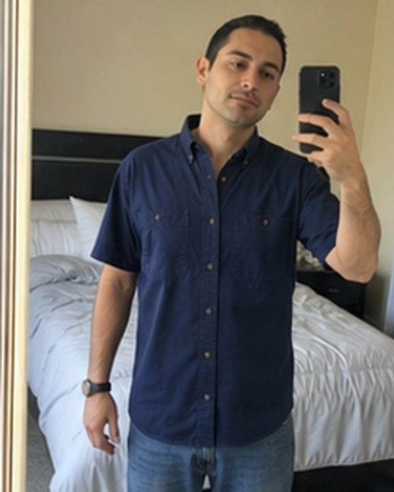 Natural phone-style photo of Men's Dual-Pocket Button-Down Work Shirt Multi-Pack