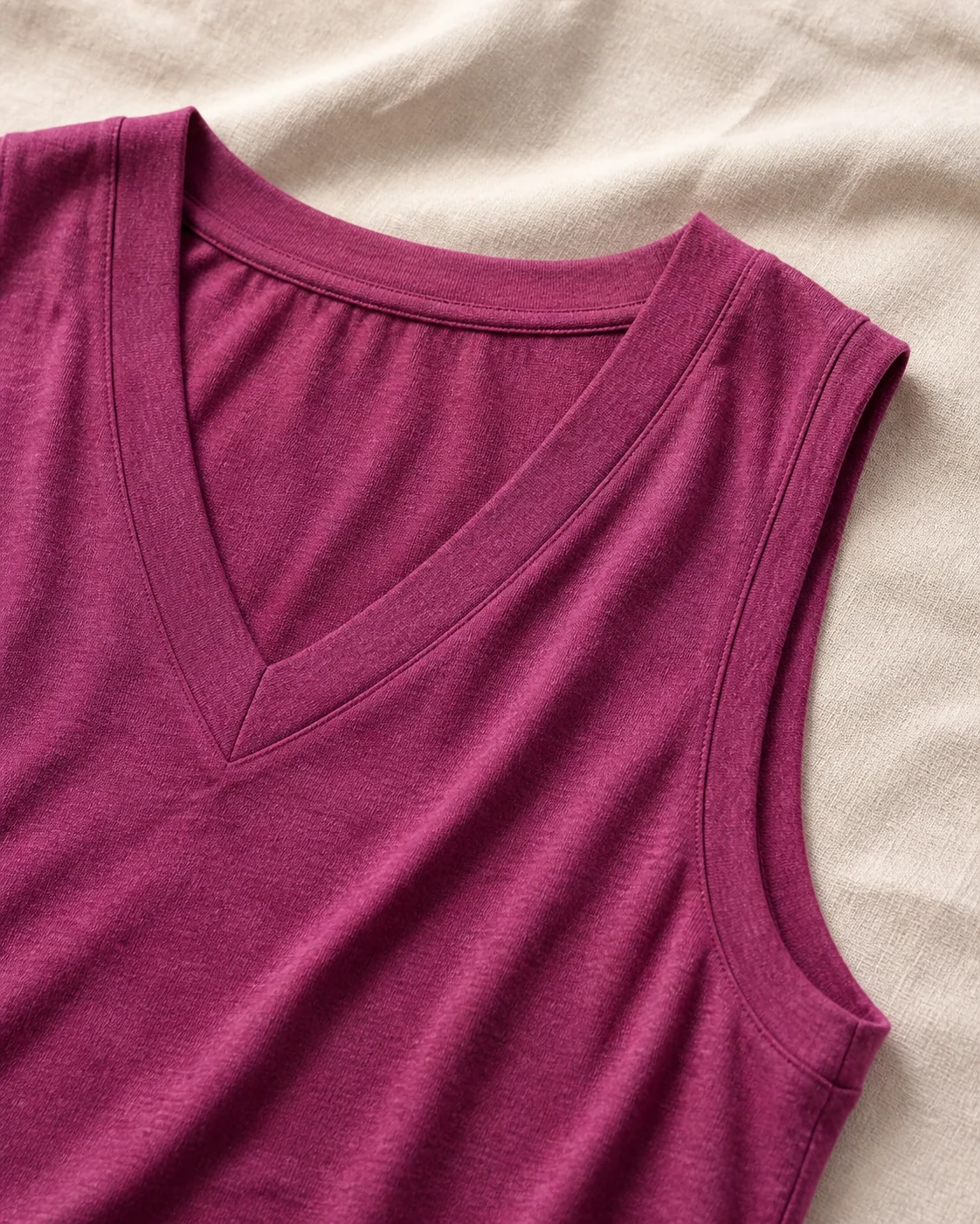 Close view of V-neck binding armhole finish and heather fabric