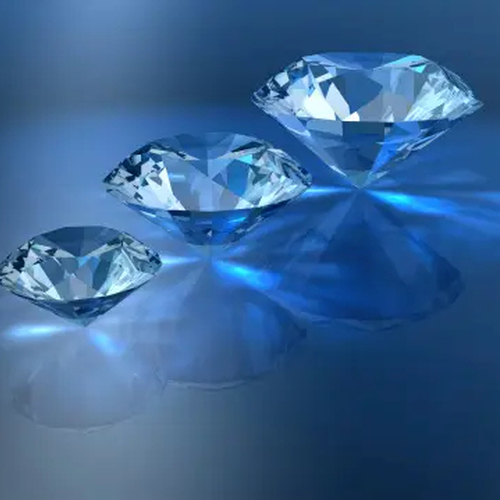 Several faceted diamonds reflected on a surface