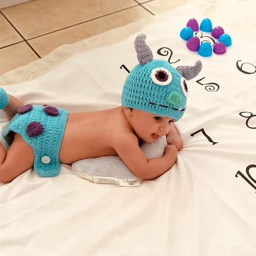 Playful baby character outfit during tummy time