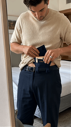 Placing a passport cards cash and travel essentials inside the hidden wallet