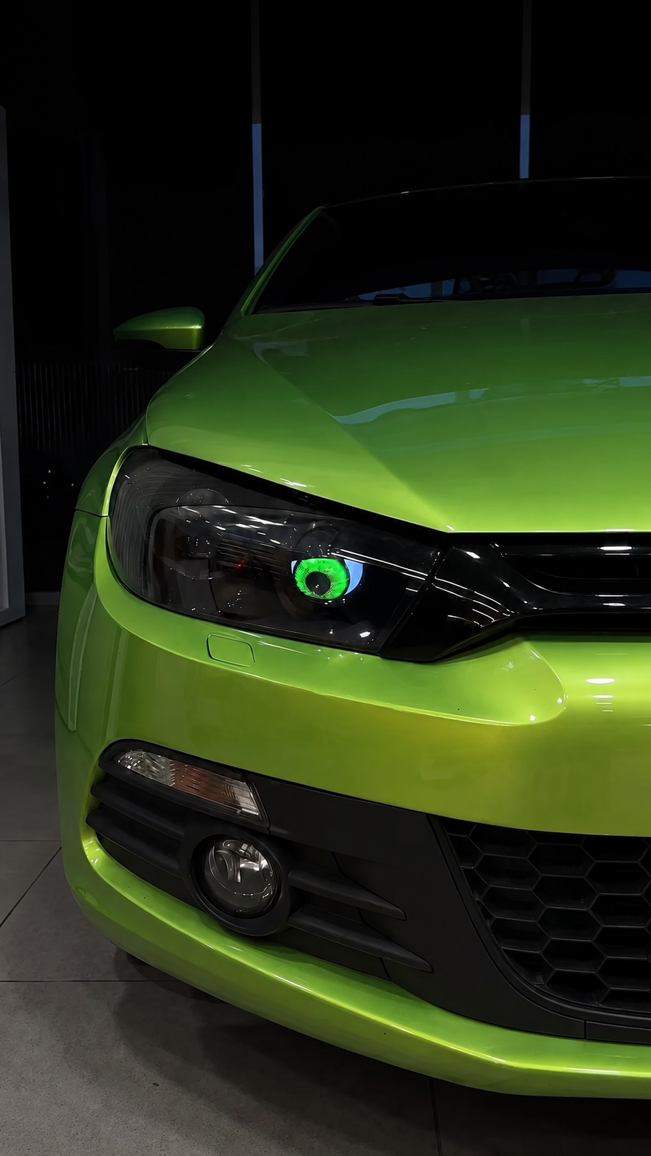 Customer green car displaying a green 3D eye headlight