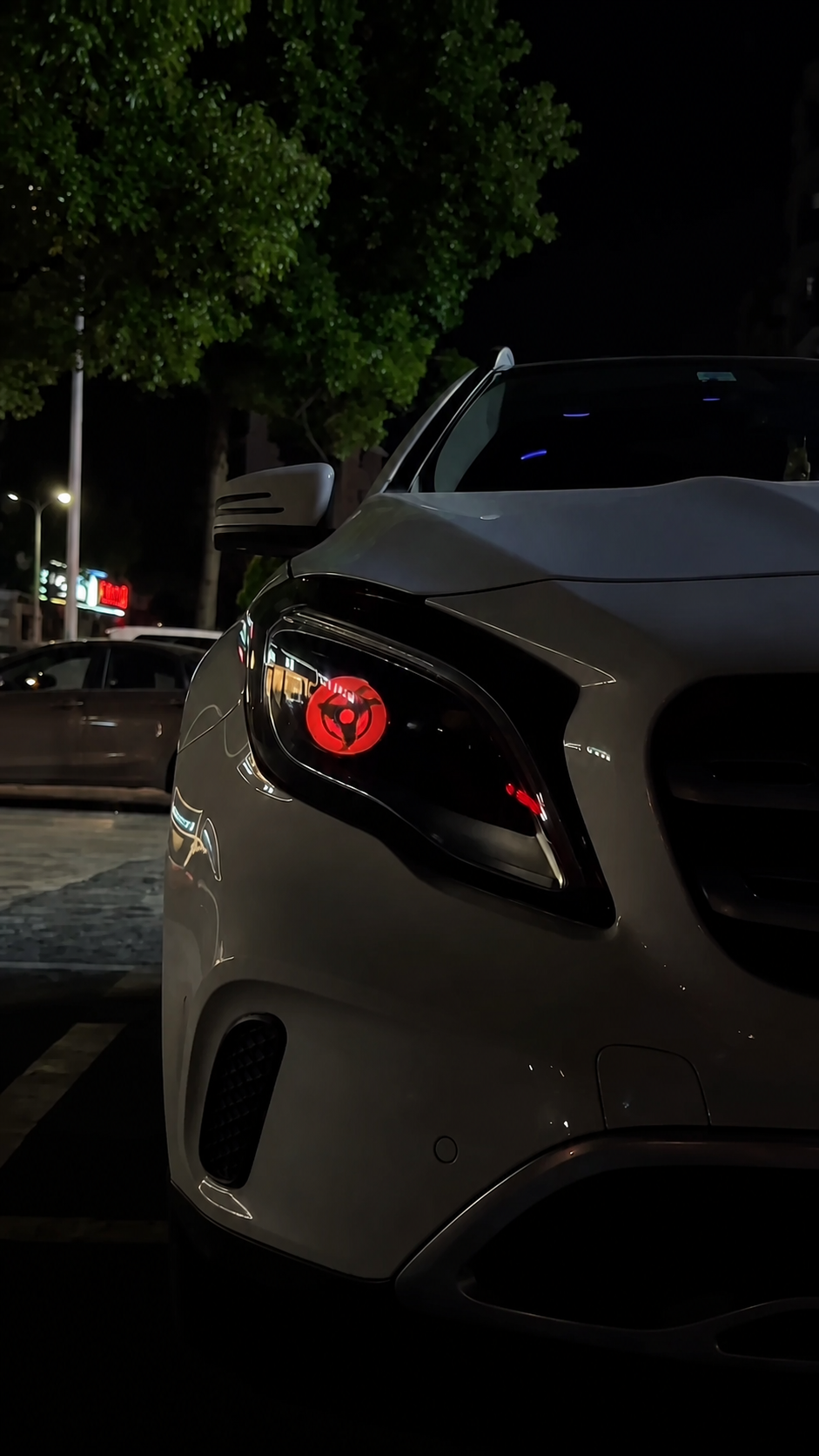 Customer white car displaying a red animated eye headlight