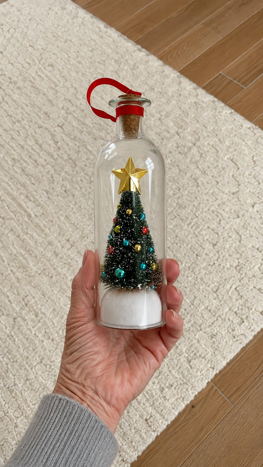 Customer displaying the recordable Christmas message bottle
