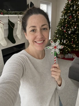 Customer holding the Snowflake Christmas payment wand at home