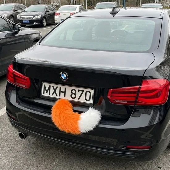 Customer car with an orange fluffy tail installed
