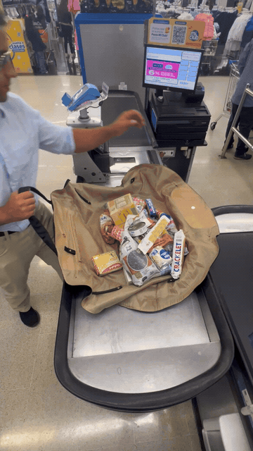 Groceries loaded onto a flat tote and lifted at checkout