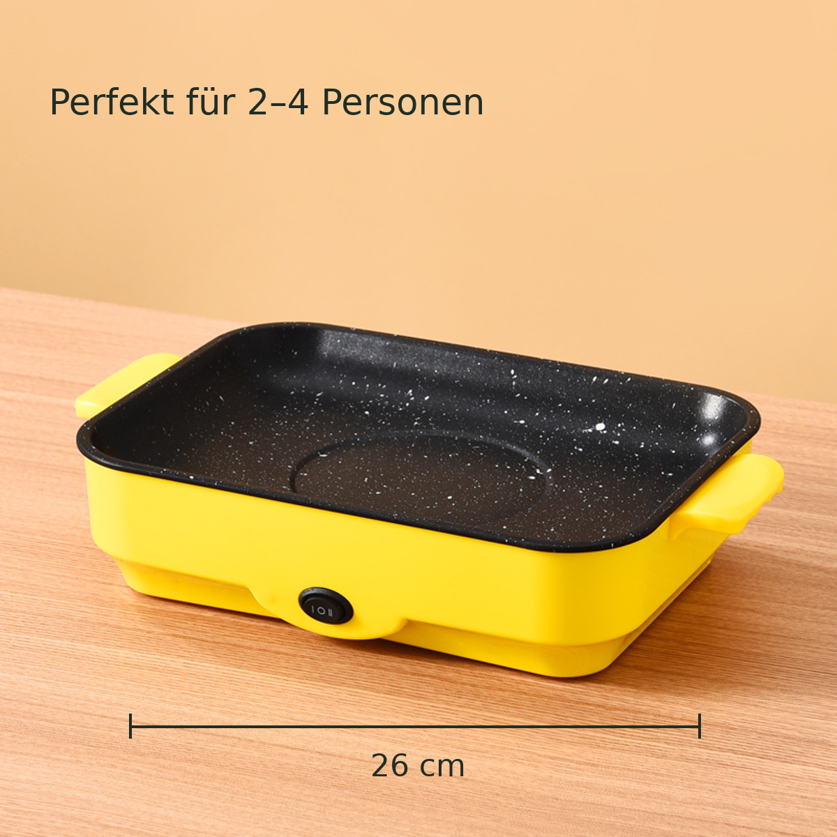 Gelber Indoor-Grill mit einer Ma&szlig;linie f&uuml;r die 26-cm-Gr&ouml;&szlig;e