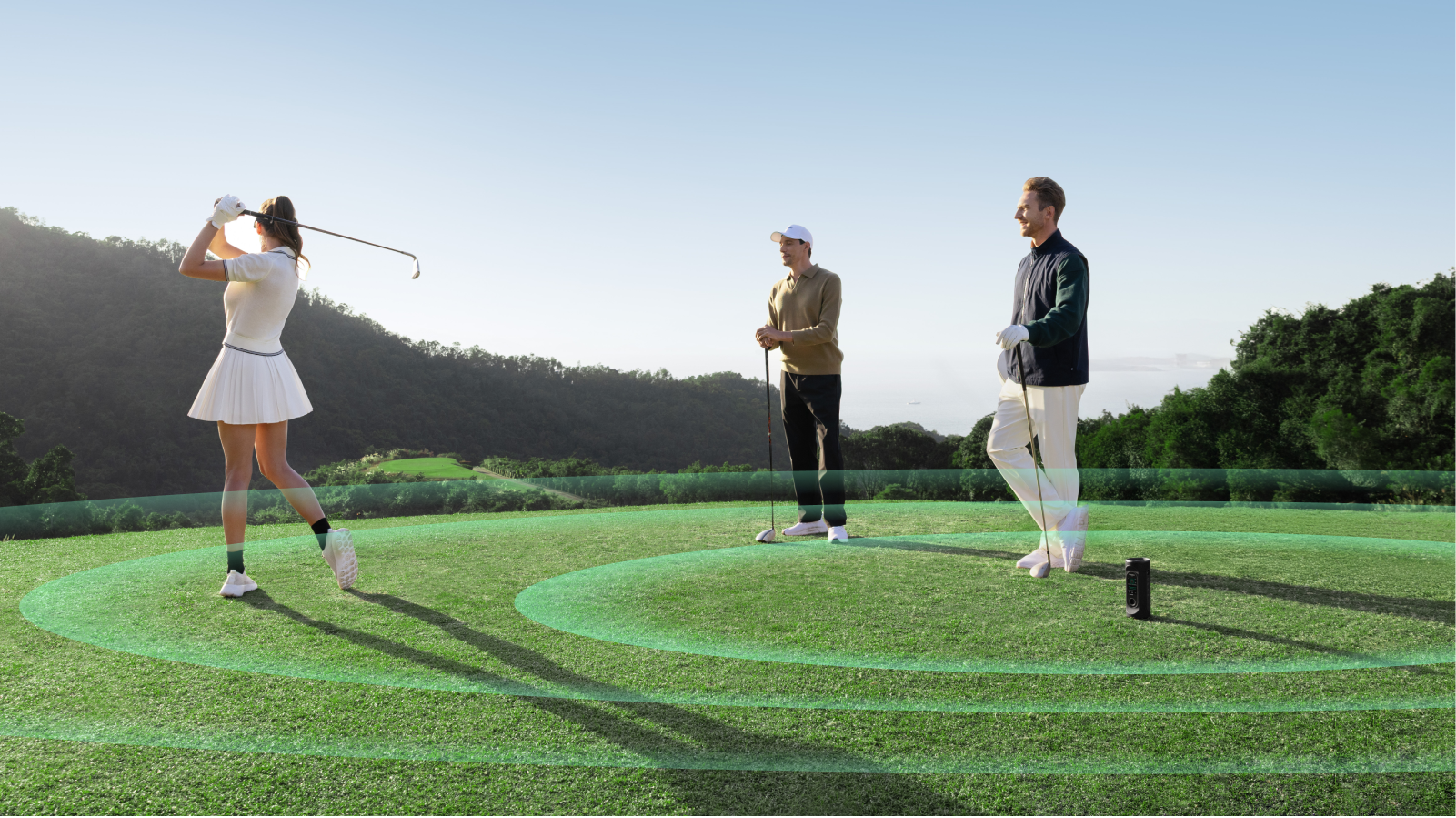 Three Golfers Playing Golf and Putting the GeneSonic Pro GPS Speaker on the Ground for Get Distance Inforamtion by Audio Function