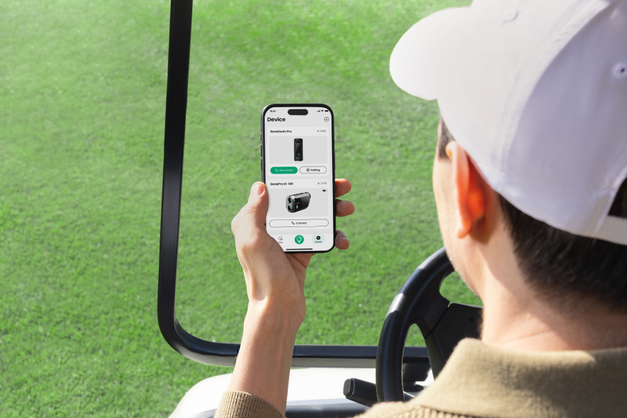 A Man Using the Mileseey Golf App to Monitor the Status of Multiple Mileseey Golf Gear