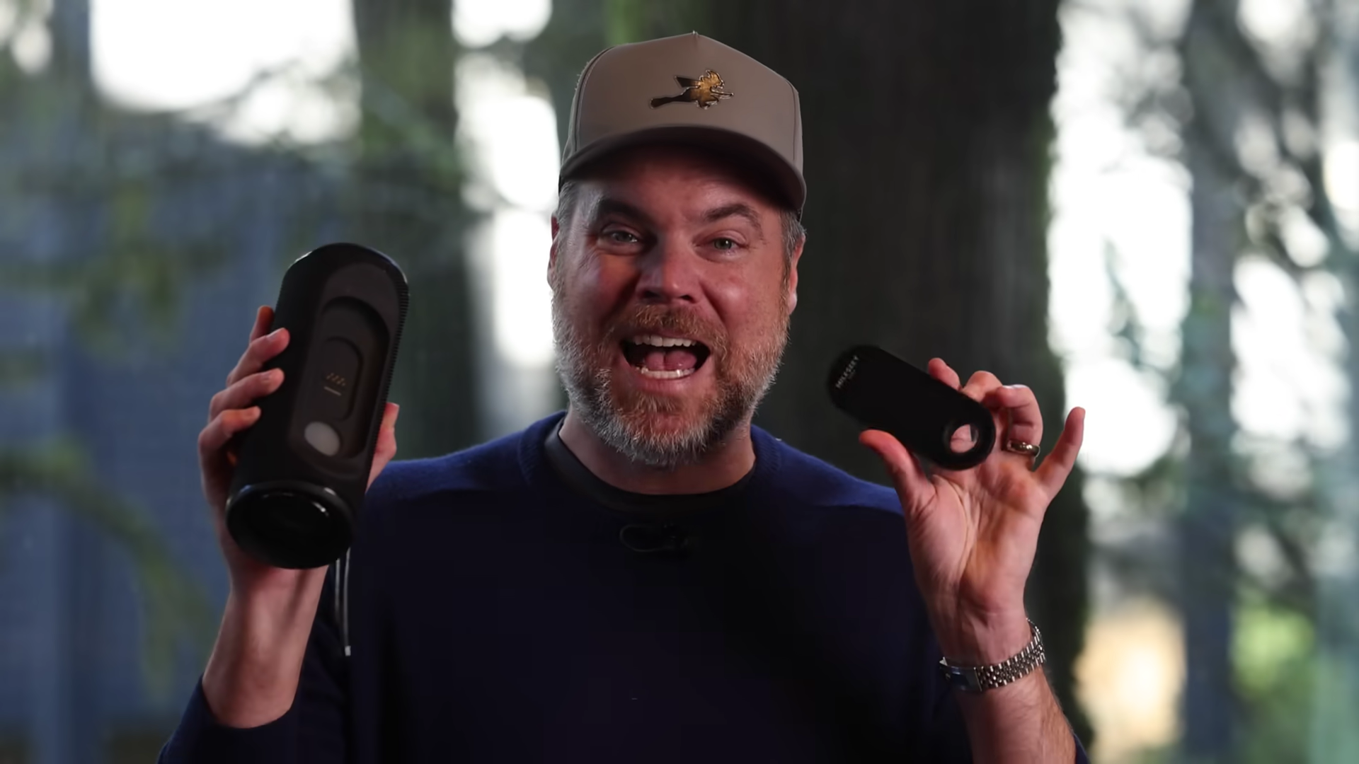 A Man with A Smile Face is Showing the Detachable Function of GeneSonic Pro GPS Speaker
