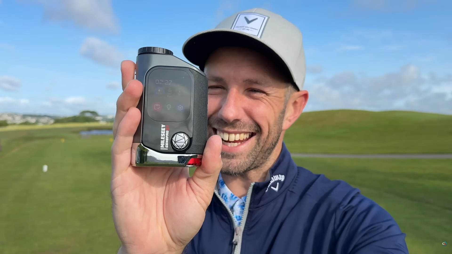 A Charismatic Smiling Man Showcasing Golfer’s Favorite Mileseey Laser Rangefinder on Course