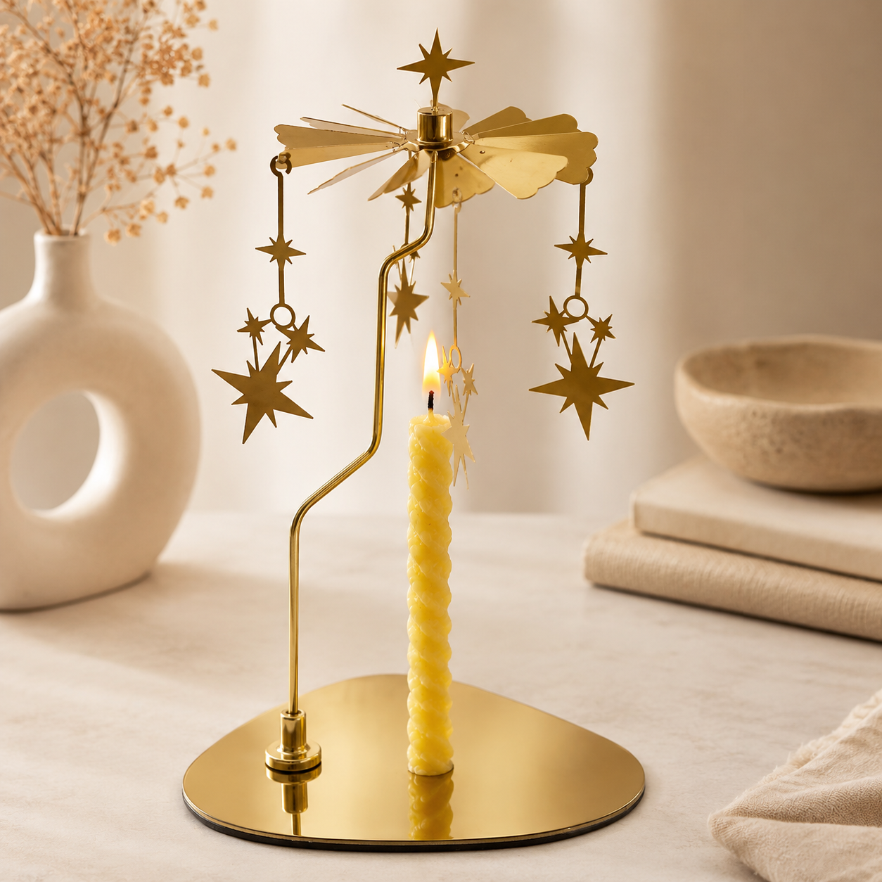 Golden candle carousel displayed on a cozy bedside table
