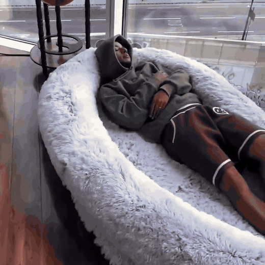 Hand pressing into the soft plush outer layer of the floor lounger