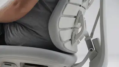 Motorized lumbar support moving toward the seated user