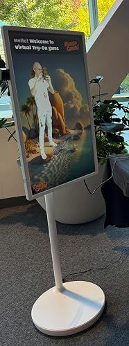 Evening phone photo of a person reclining in the white chair with legs on the separate footrest