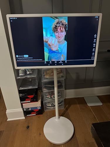 Customer aligning the white chair armrest with a compact home-office desk