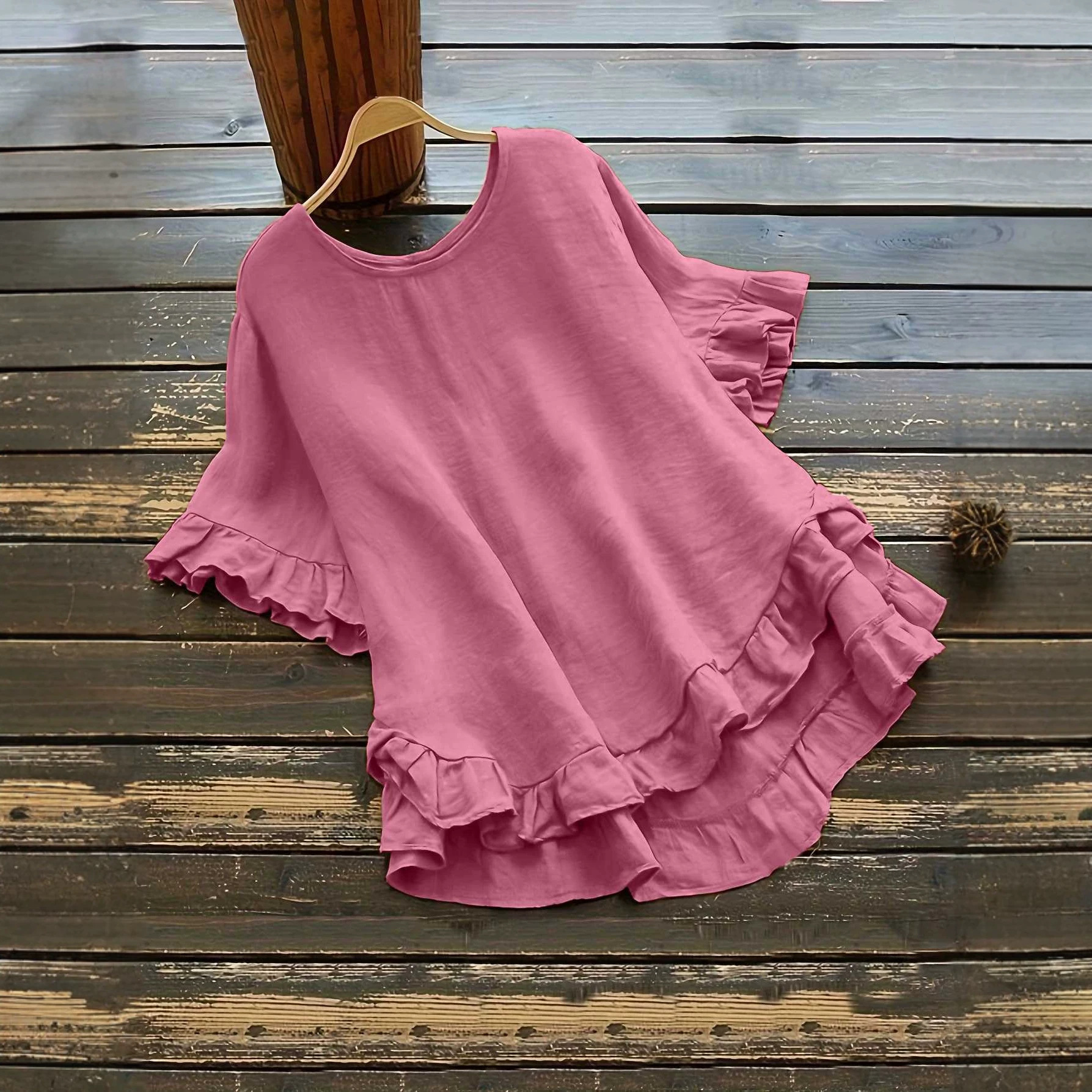 Buttonless ice silk ruffled hem top with front short and back long design, bell sleeves, and round neck