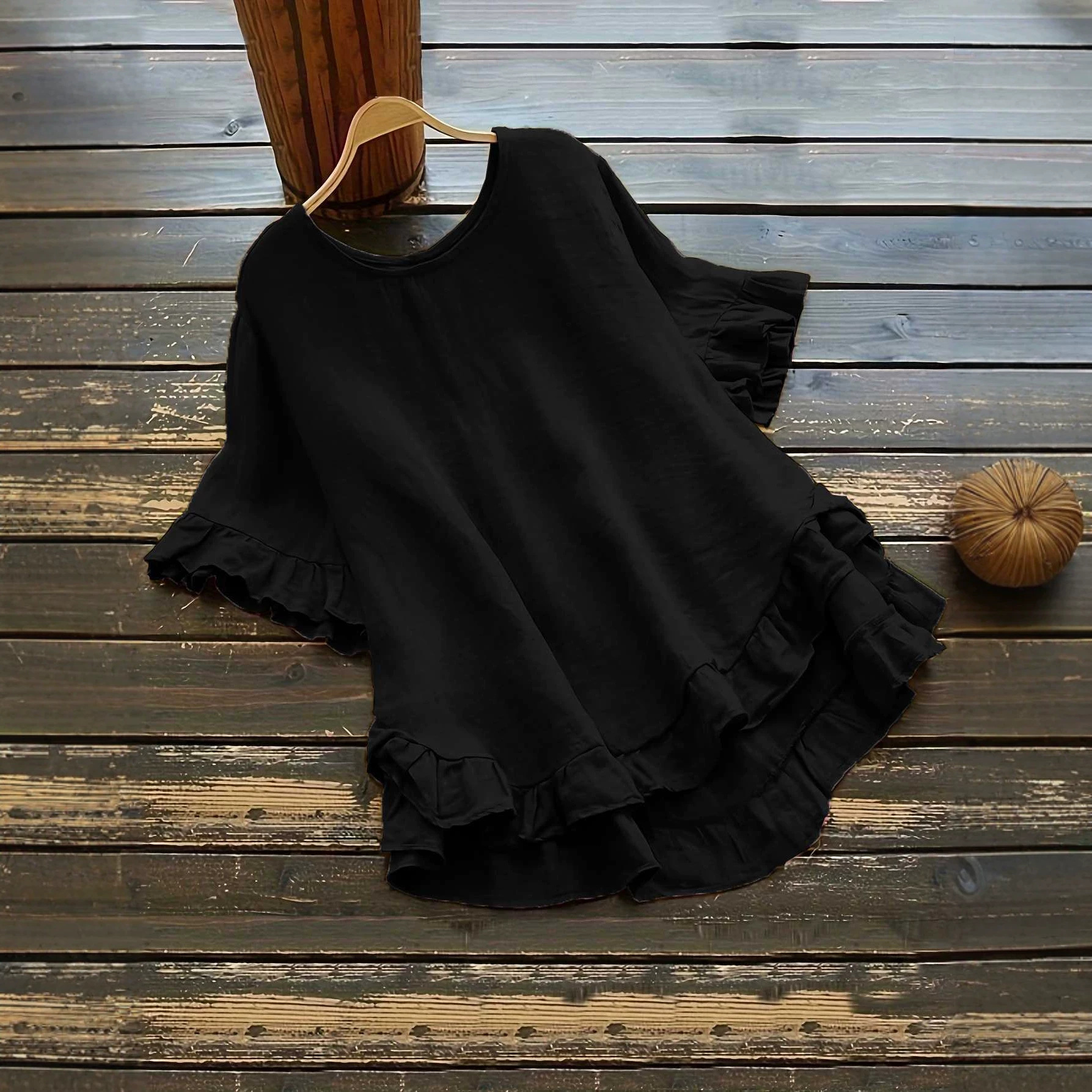 Buttonless ice silk ruffled hem top with front short and back long design, bell sleeves, and round neck