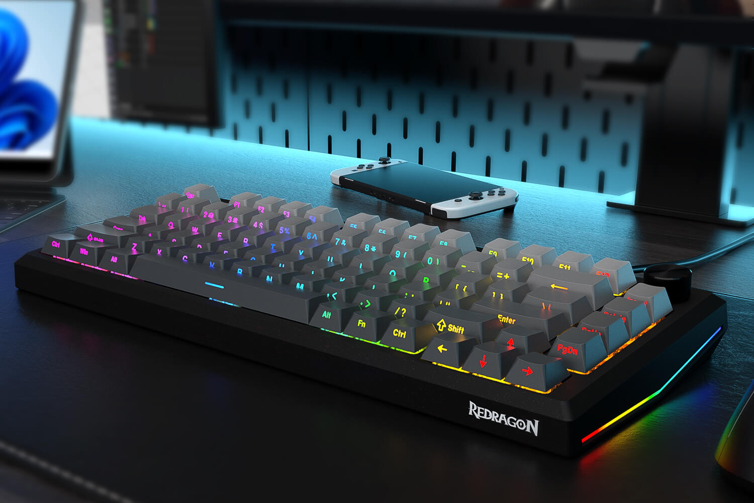 RGB keyboard with Redragon branding on a desk setup