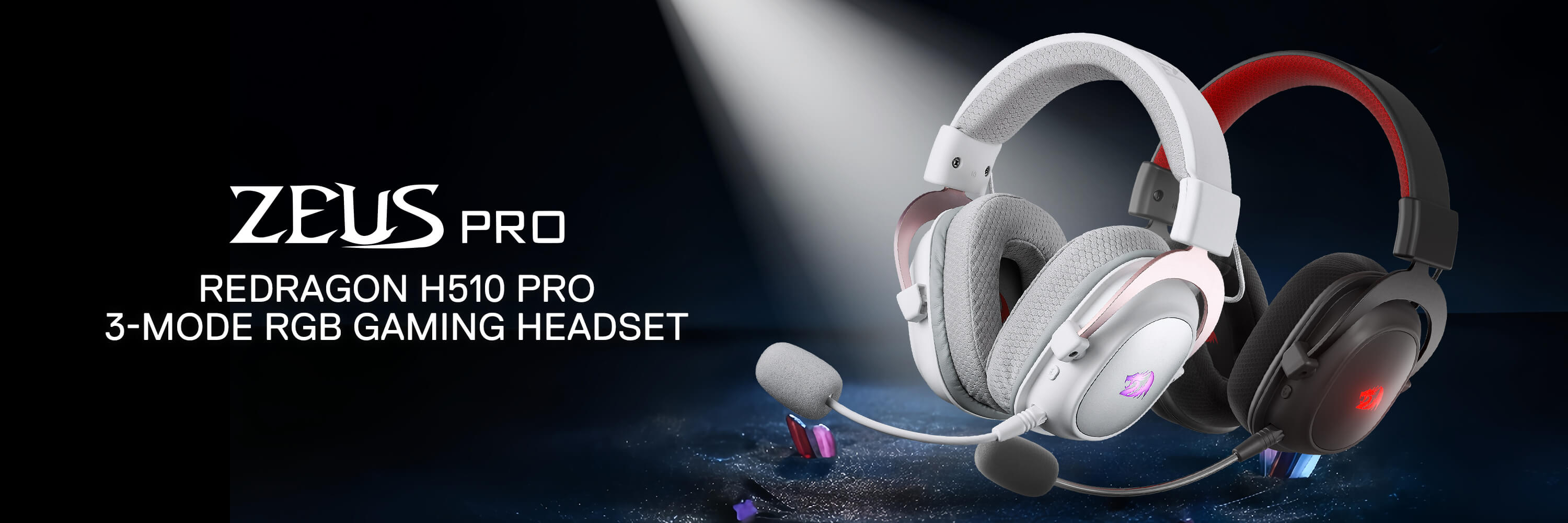 Redragon H510 ZEUS-X RGB wireless gaming headset displayed on a gaming desk setup with a glowing blue and red RGB mat, featuring wireless connectivity, over-ear design, and customizable RGB lighting