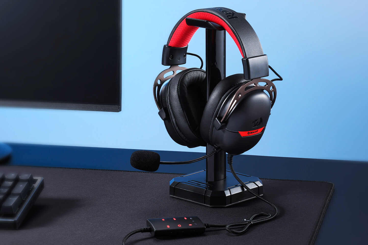 Redragon AURORA H376 gaming headset in black with a professional desktop setup