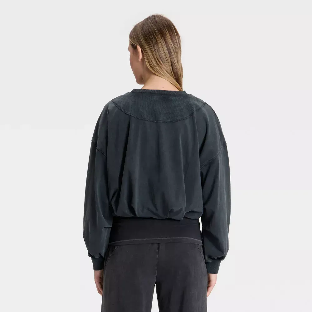 Black bubble-hem long sleeve top, back view