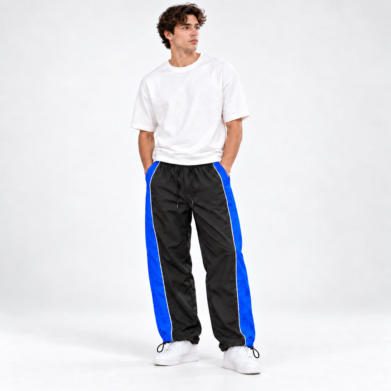Men's black and blue piped cinch-hem track pants front view