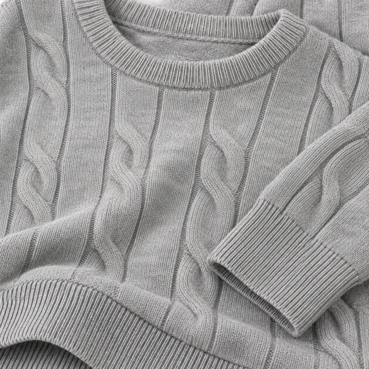 Cable-knit front, ribbed crew neck, cuffs and hem details