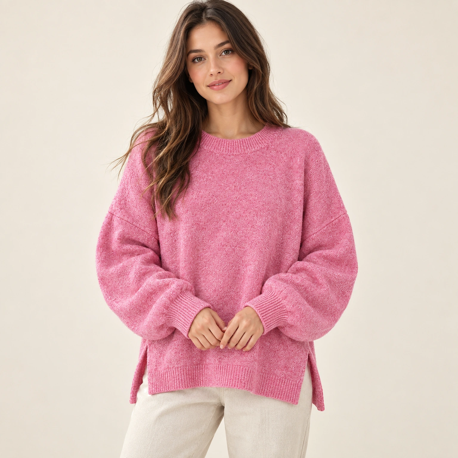 Woman wearing the pink drop-shoulder split-hem knit sweater, front view