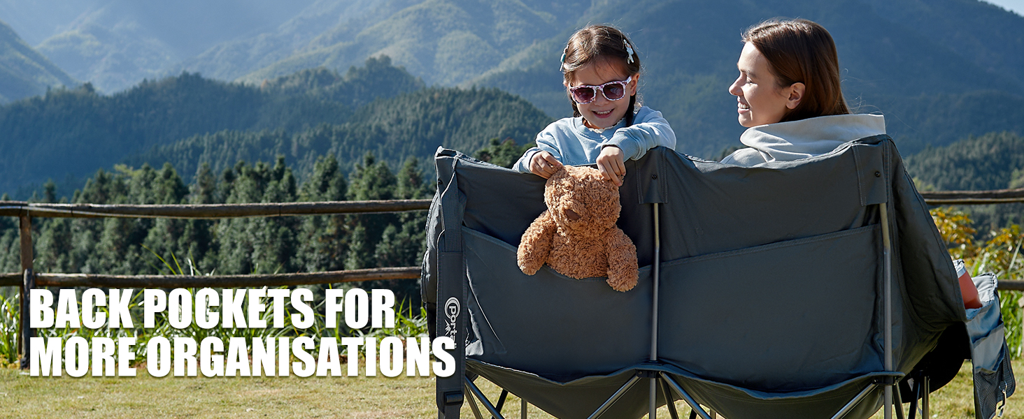 a young girl holding a teddy bear in a chair.