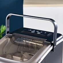 Gray electronic device with a transparent lid, metal handle, and black control panel featuring multiple buttons on top.