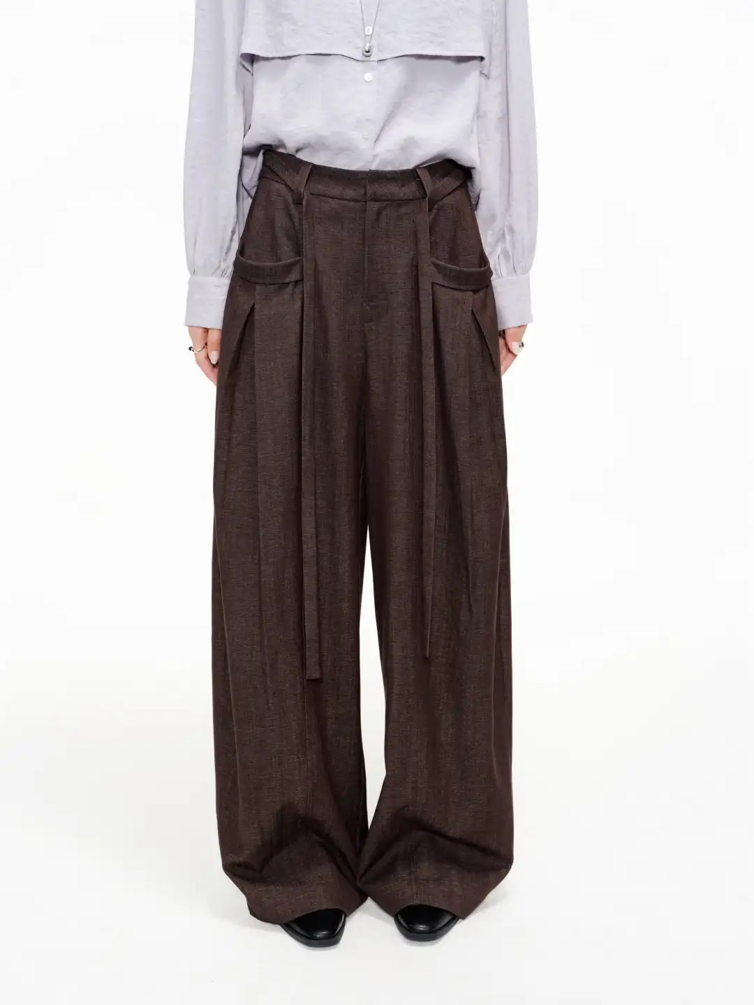 Dark brown wide-leg trousers with front pleats and a draped waistband