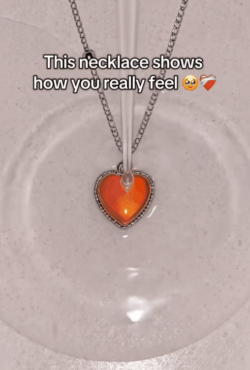 The Aura Color Heart mood necklace changing color while worn