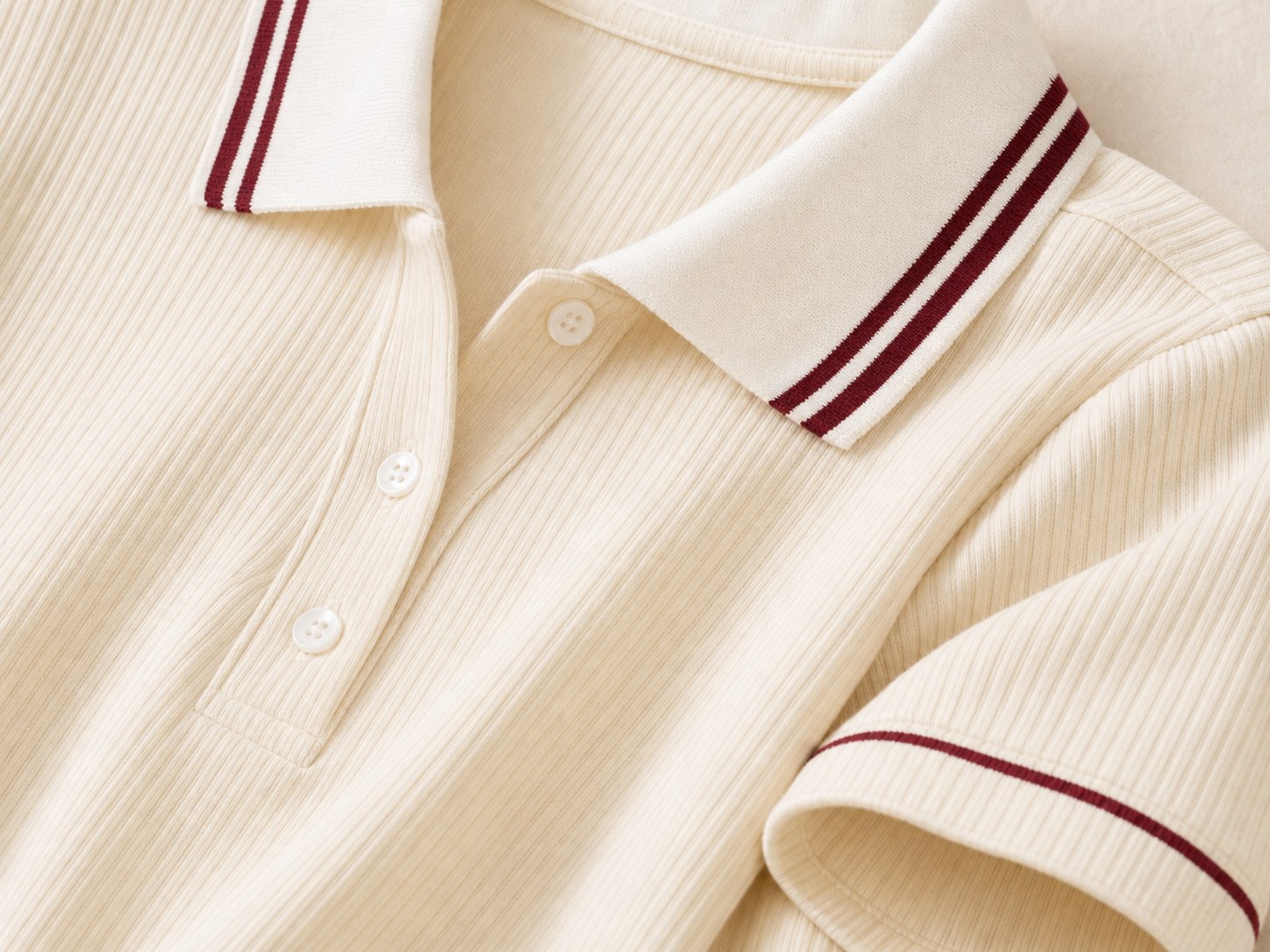 Close-up detail of ribbed polo collar and contrast stripe trim