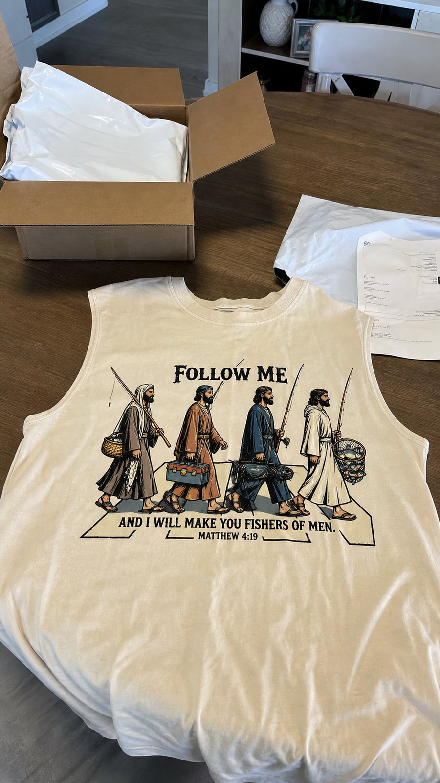 Buyer arrival photo with opened package and ivory sleeveless tee