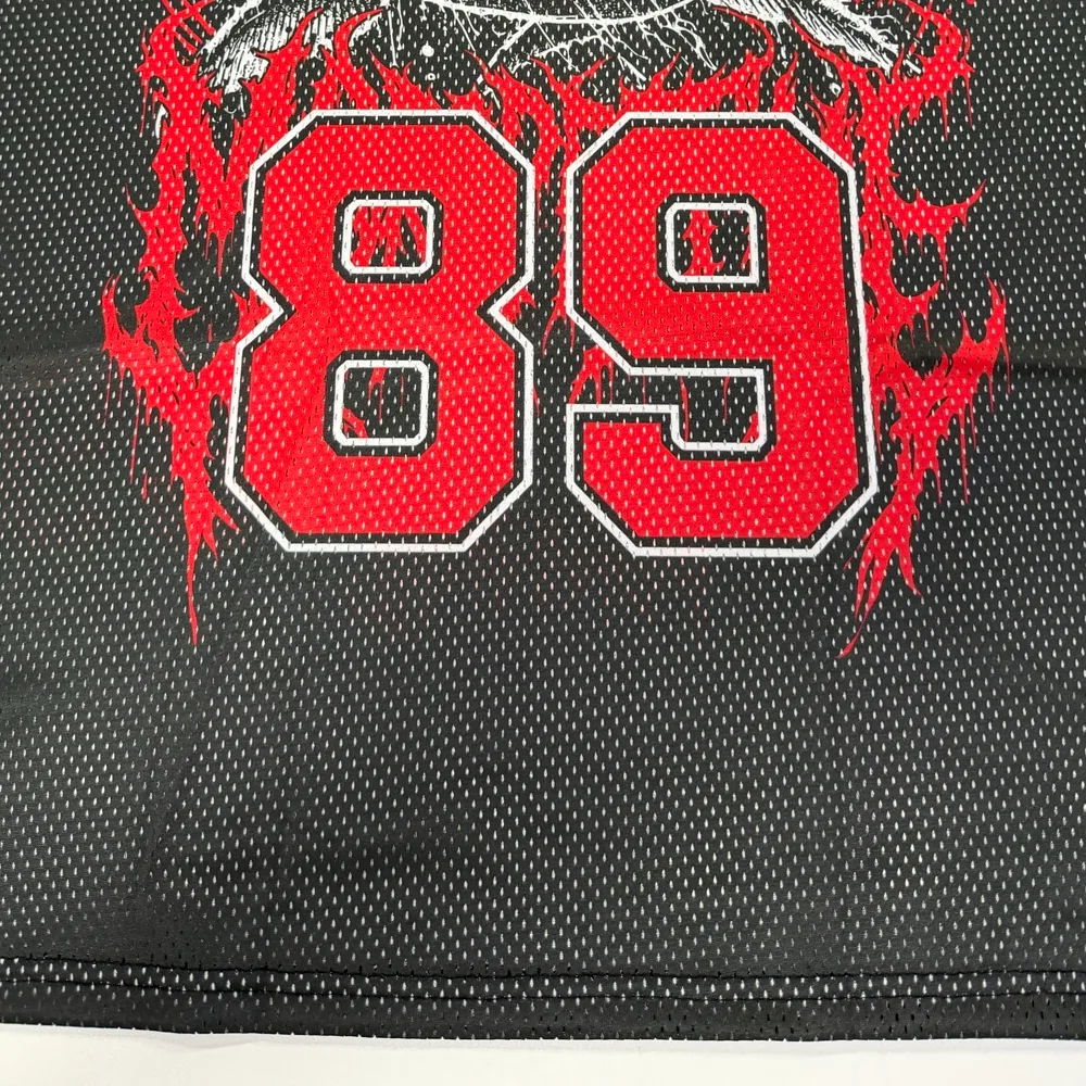 Real Mesh Jersey sample close-up showing printed mesh, hem, and stitching