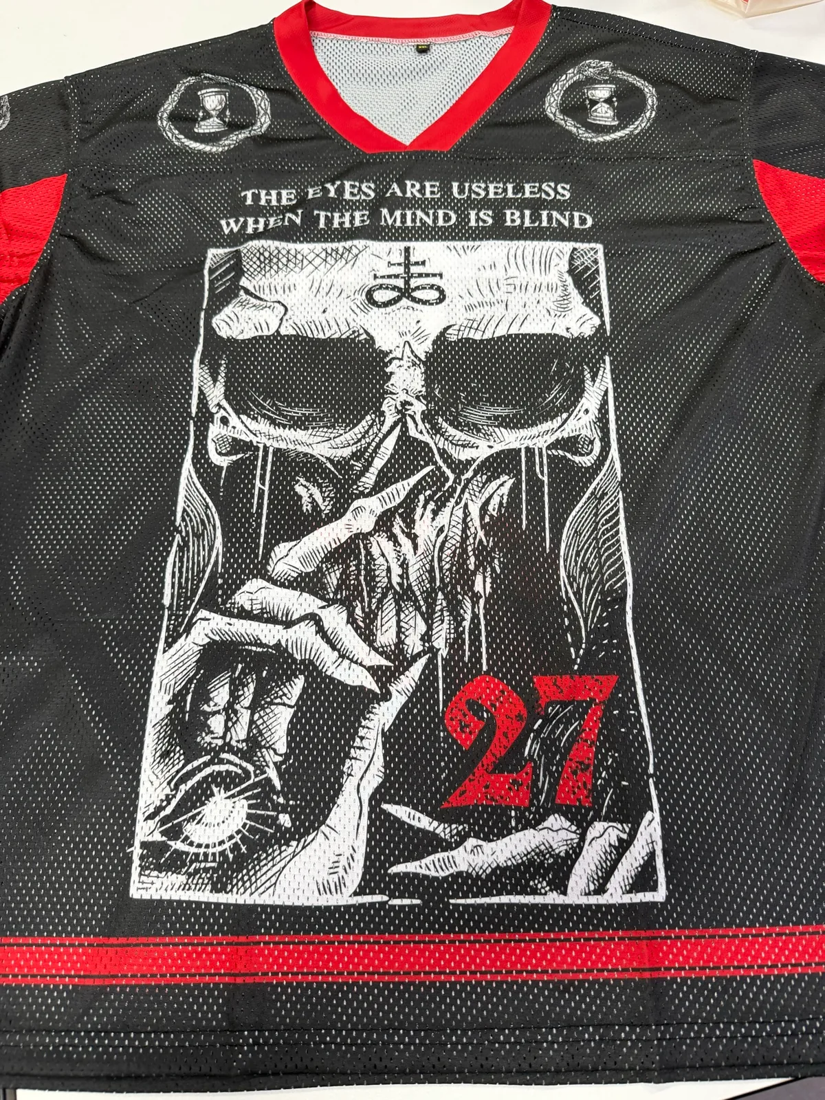 Eyes Are Useless 27 Mesh Jersey real product photo, front graphic and red V-neck