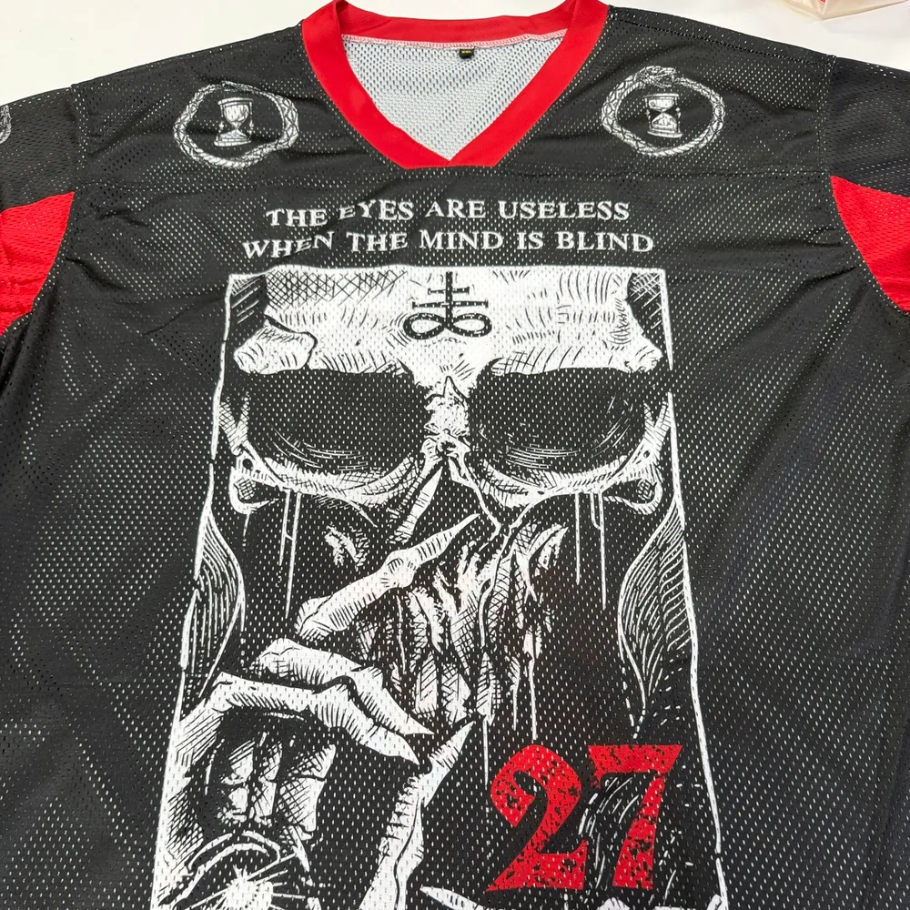 Real Mesh Jersey sample showing the solid V-neck binding and perforated printed fabric