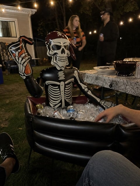 Pirate skeleton cooler at a casual nighttime backyard party