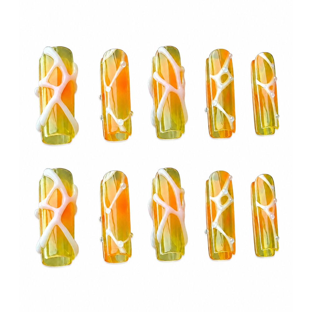 Glossy coffin press-on nails with a translucent orange amber ombre base, wrapped in 3D fluid white lines and dots.